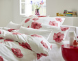 Bett mit Bio Satin Bettwäsche aus reiner Bio-Baumwolle im Design Mohnblume von Cotonea